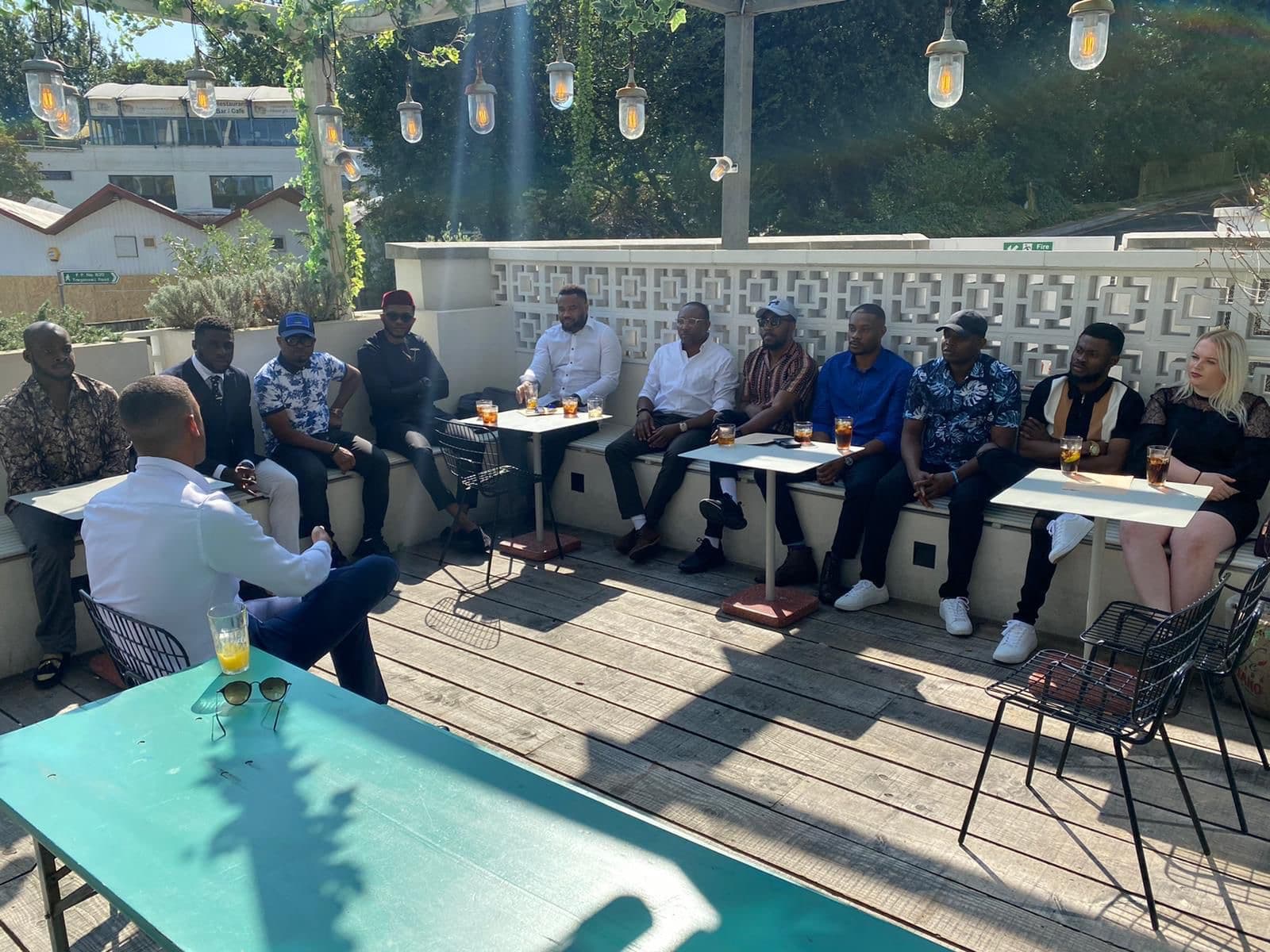 Outdoor seminar in session under festoon lights.